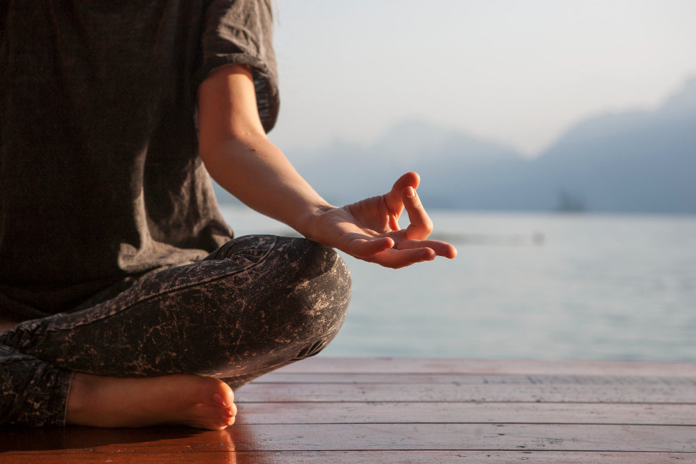 A woman meditating peacefully, symbolizing inner calm, mindfulness, and the natural wellness philosophy of Zororra.