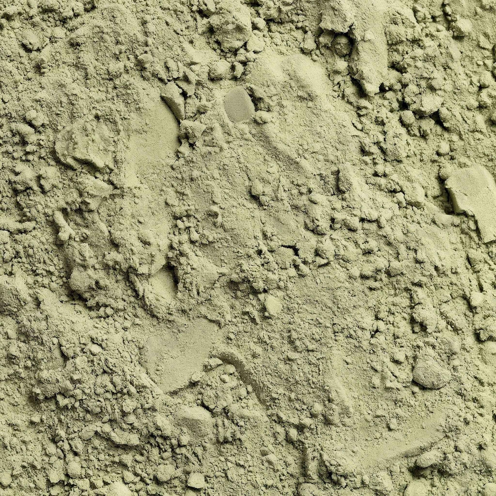 Close-up of green herbal supplement powder, suitable for wellness and natural energy.