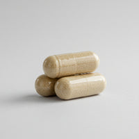 Two beige capsules on a white background 